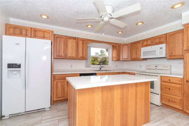 kitchen featuring ceiling fan, sink, white appliances, a textured ceiling, and a center island