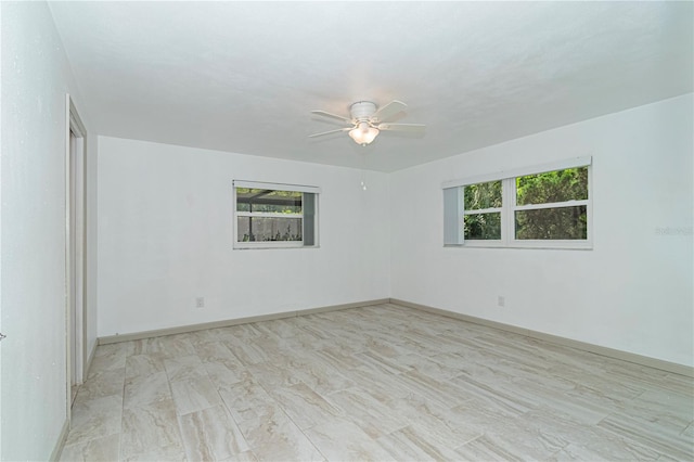 unfurnished room with ceiling fan