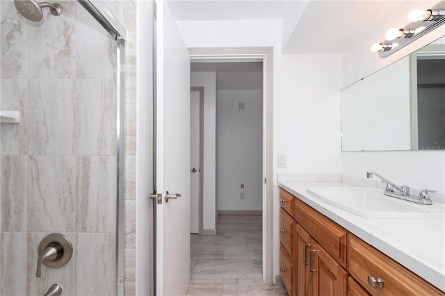 bathroom with walk in shower and vanity