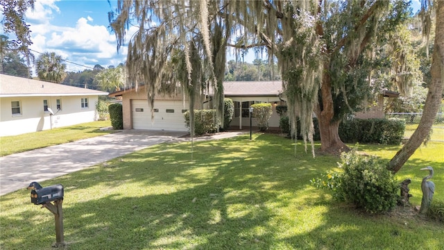 view of front facade with a garage and a front lawn