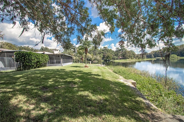 view of yard with a water view and a sunroom