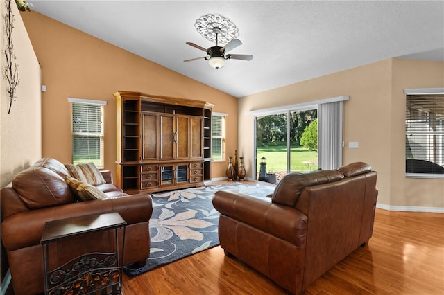 living room with light wood-type flooring, lofted ceiling, and ceiling fan