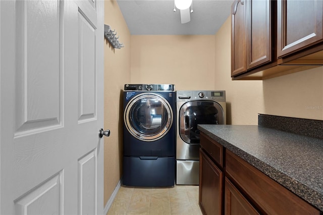 clothes washing area with cabinets and independent washer and dryer