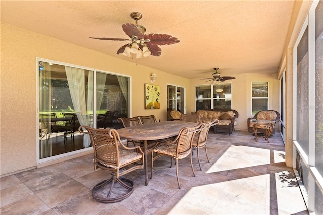 sunroom featuring ceiling fan