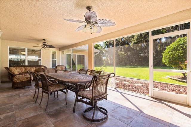 sunroom / solarium featuring ceiling fan