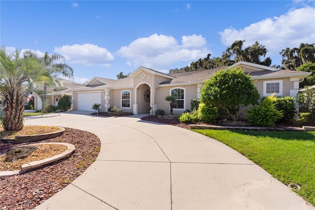 mediterranean / spanish-style home with a garage and a front yard