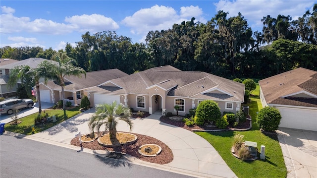 view of front of house featuring a garage and a front lawn