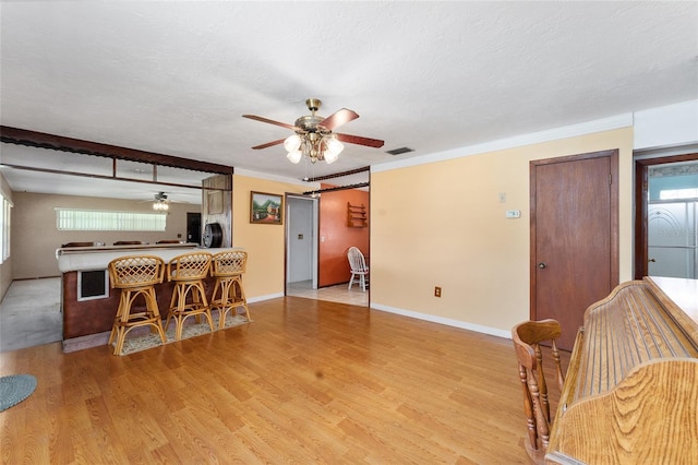 kitchen featuring a barn door, crown molding, light wood-type flooring, and a wealth of natural light