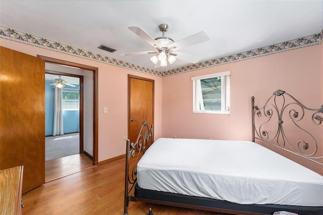 bedroom with light wood-type flooring and ceiling fan