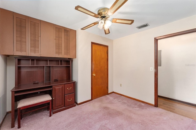 unfurnished office with ceiling fan and light colored carpet