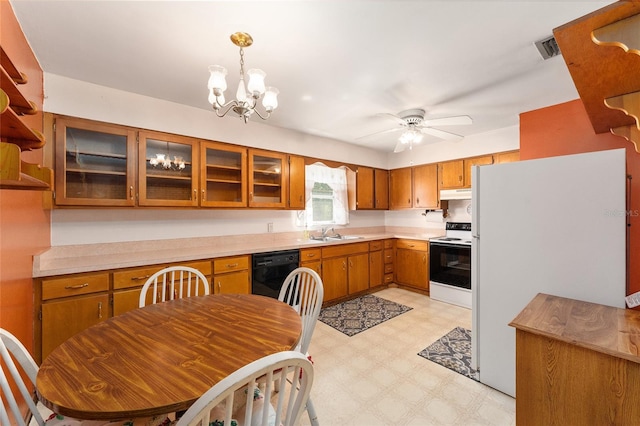 kitchen featuring pendant lighting, ceiling fan with notable chandelier, sink, and white appliances