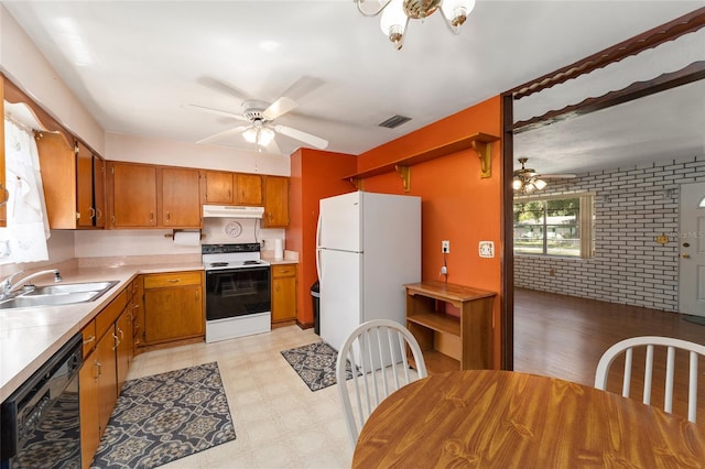 kitchen featuring ceiling fan, sink, white appliances, brick wall, and light wood-type flooring