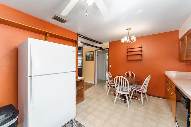 kitchen featuring ceiling fan with notable chandelier, black dishwasher, pendant lighting, and white refrigerator