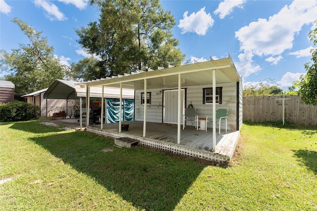 back of property featuring a lawn and a deck