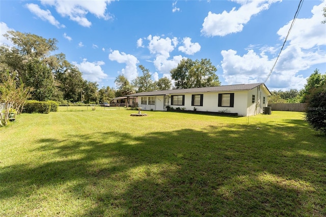 exterior space featuring central AC and a yard