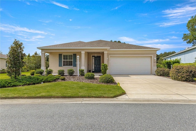 view of front of property featuring a front lawn and a garage