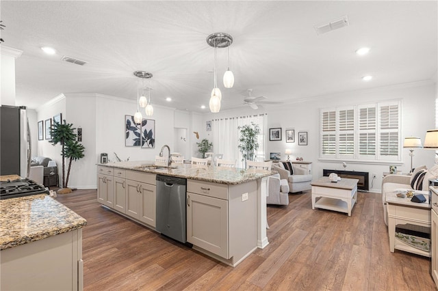 kitchen featuring pendant lighting, sink, appliances with stainless steel finishes, and dark wood-type flooring