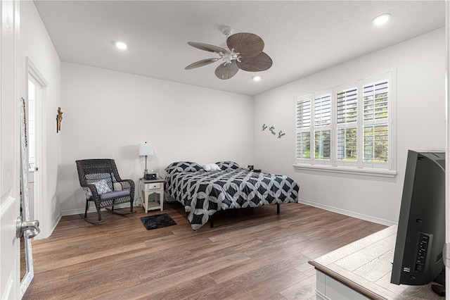 bedroom featuring hardwood / wood-style floors and ceiling fan