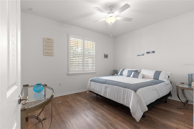 bedroom with ceiling fan and dark wood-type flooring