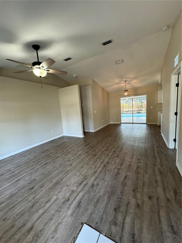 unfurnished living room with dark hardwood / wood-style flooring and ceiling fan