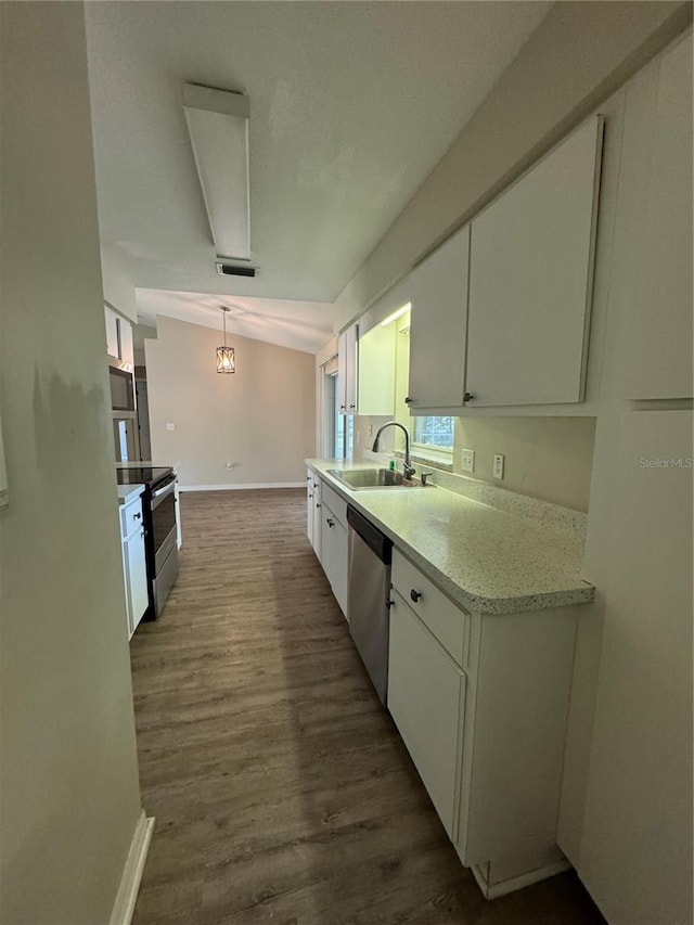 kitchen featuring sink, decorative light fixtures, dark hardwood / wood-style flooring, white cabinetry, and stainless steel appliances