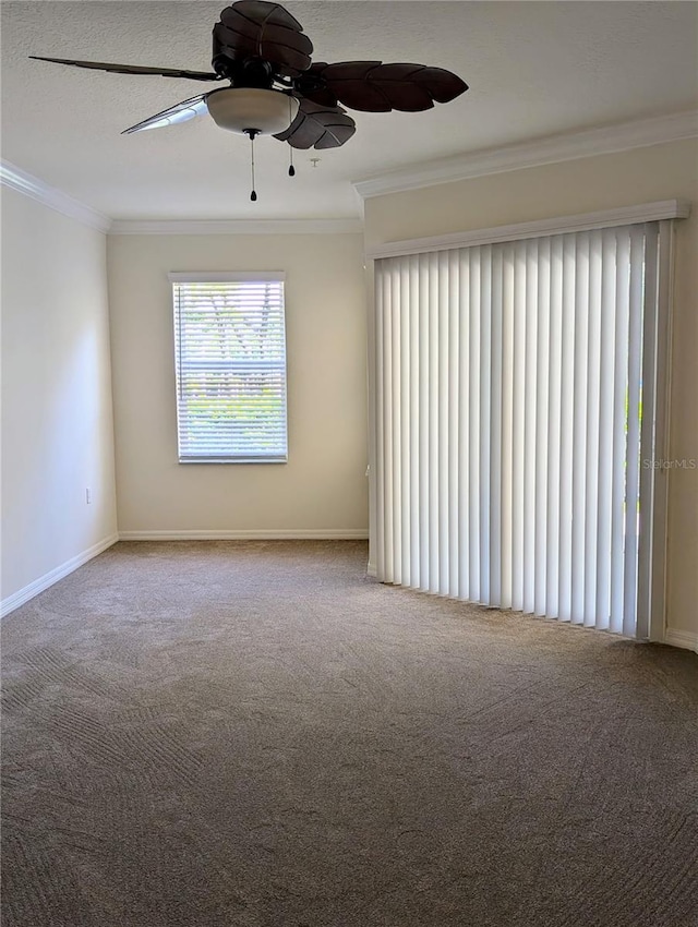 carpeted empty room featuring ornamental molding, a textured ceiling, and ceiling fan