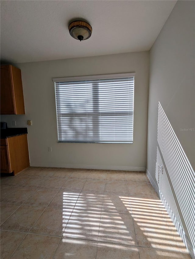 interior space with light tile patterned flooring and plenty of natural light