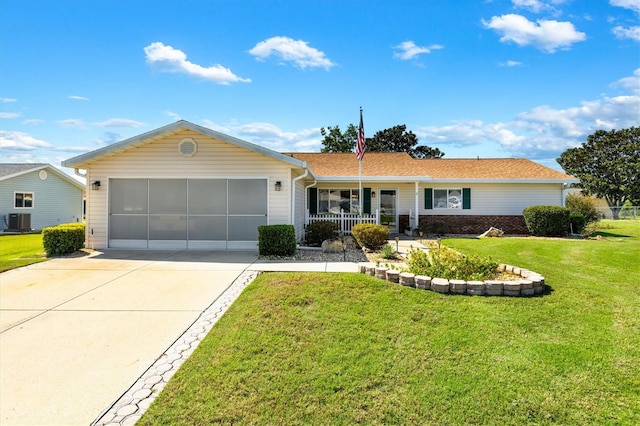 single story home with a front yard, cooling unit, a garage, and covered porch