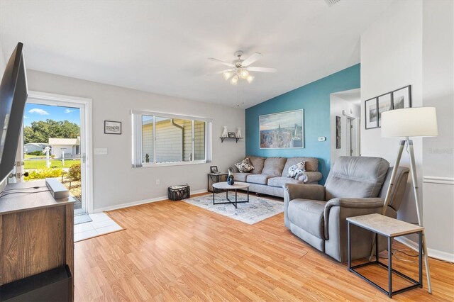 living room with lofted ceiling, light hardwood / wood-style floors, and ceiling fan