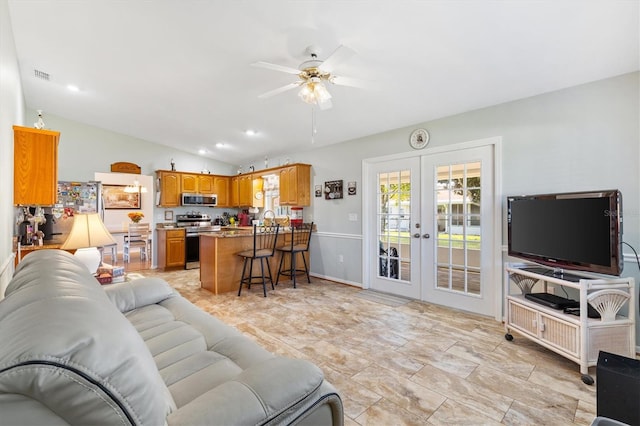 living room featuring french doors, lofted ceiling, and ceiling fan