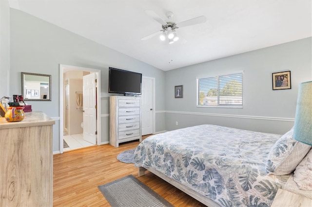 bedroom with wood-type flooring, vaulted ceiling, connected bathroom, and ceiling fan