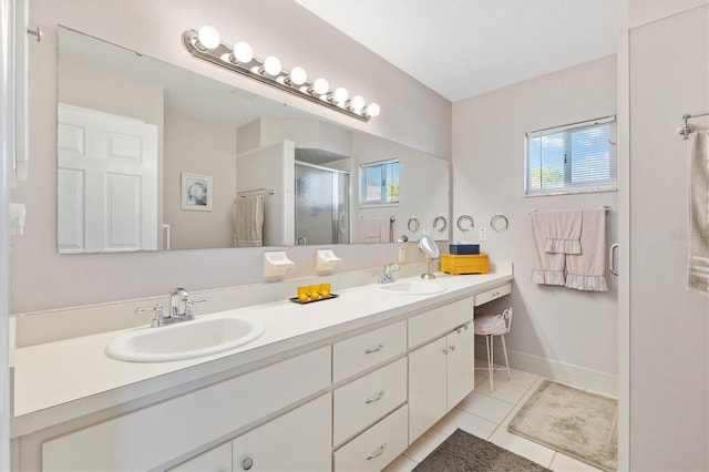 bathroom featuring vanity, a shower with shower door, and tile patterned floors