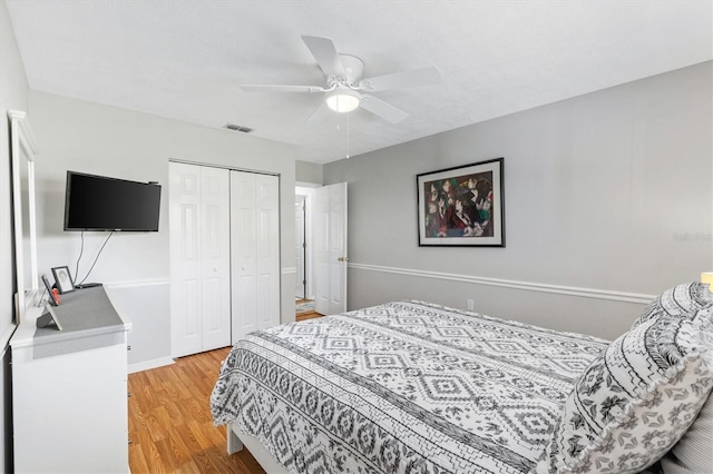 bedroom featuring ceiling fan, hardwood / wood-style flooring, and a closet