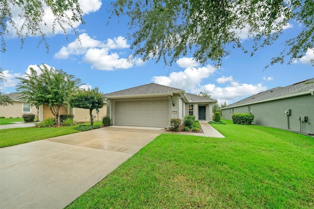 ranch-style house featuring a garage and a front lawn