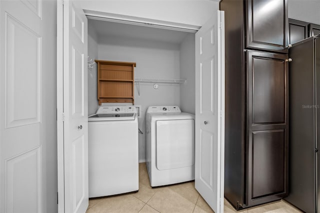 washroom featuring light tile patterned floors and washer and dryer