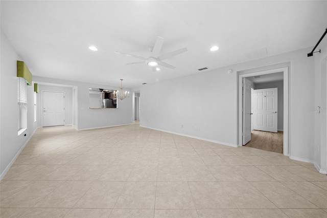 unfurnished living room with ceiling fan with notable chandelier