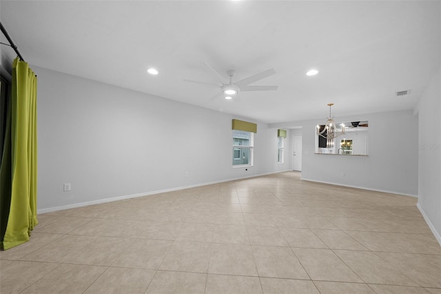 unfurnished living room featuring ceiling fan with notable chandelier and light tile patterned flooring