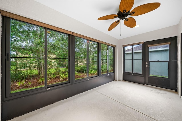 unfurnished sunroom featuring ceiling fan