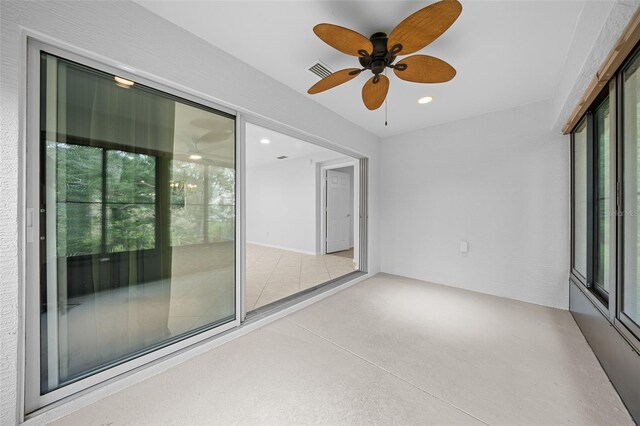 unfurnished sunroom featuring ceiling fan