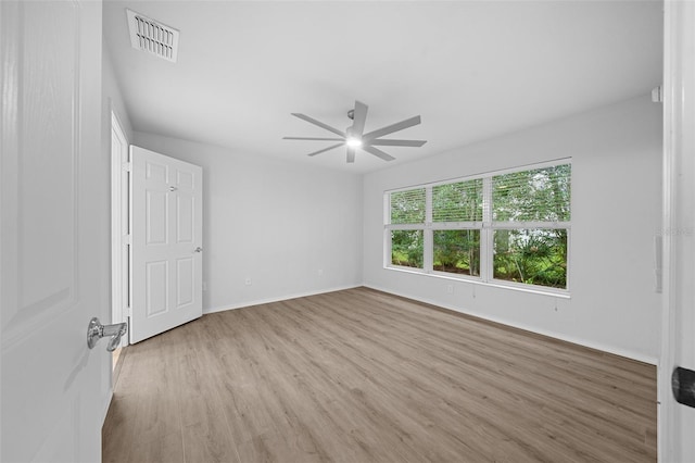 spare room featuring ceiling fan and light hardwood / wood-style flooring