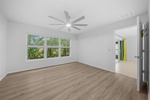 spare room featuring light wood-type flooring and ceiling fan