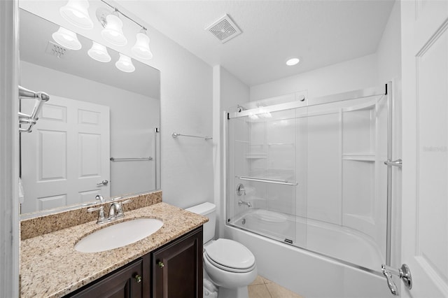 full bathroom featuring shower / bath combination with glass door, vanity, tile patterned flooring, and toilet