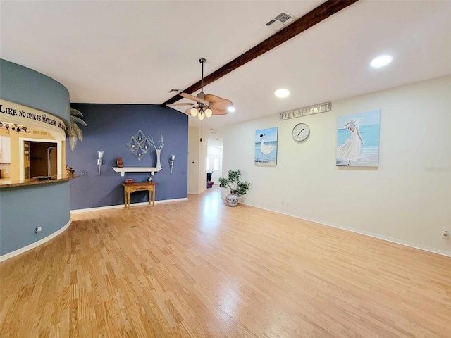 interior space with ceiling fan, light wood-type flooring, and lofted ceiling with beams