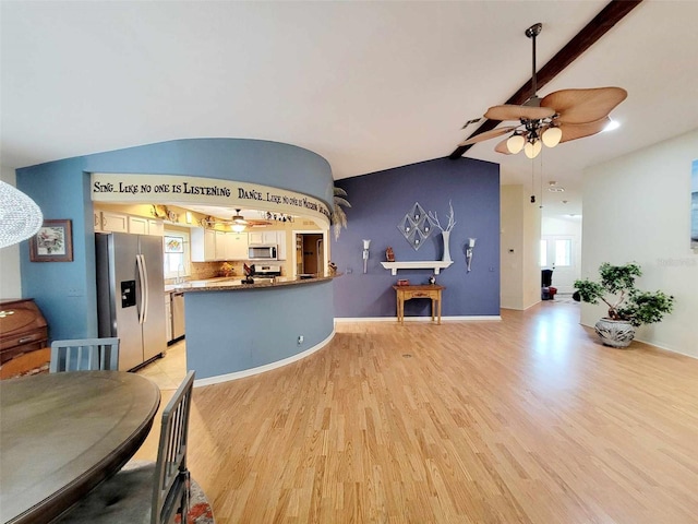 kitchen featuring lofted ceiling with beams, stainless steel appliances, white cabinets, kitchen peninsula, and light hardwood / wood-style flooring