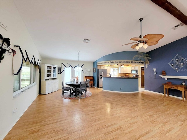 dining area with ceiling fan, light hardwood / wood-style flooring, and lofted ceiling with beams