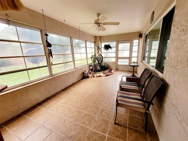 sunroom / solarium featuring ceiling fan