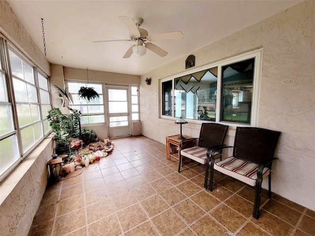 sunroom featuring ceiling fan