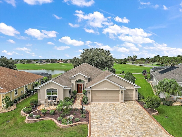 ranch-style house featuring a water view, a garage, and a front lawn