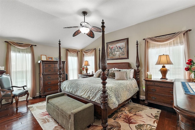 bedroom featuring multiple windows, lofted ceiling, dark hardwood / wood-style floors, and ceiling fan