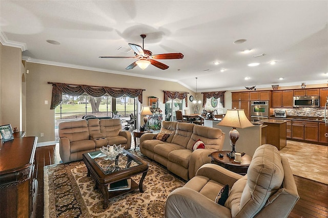 living room with ornamental molding, wood-type flooring, and ceiling fan